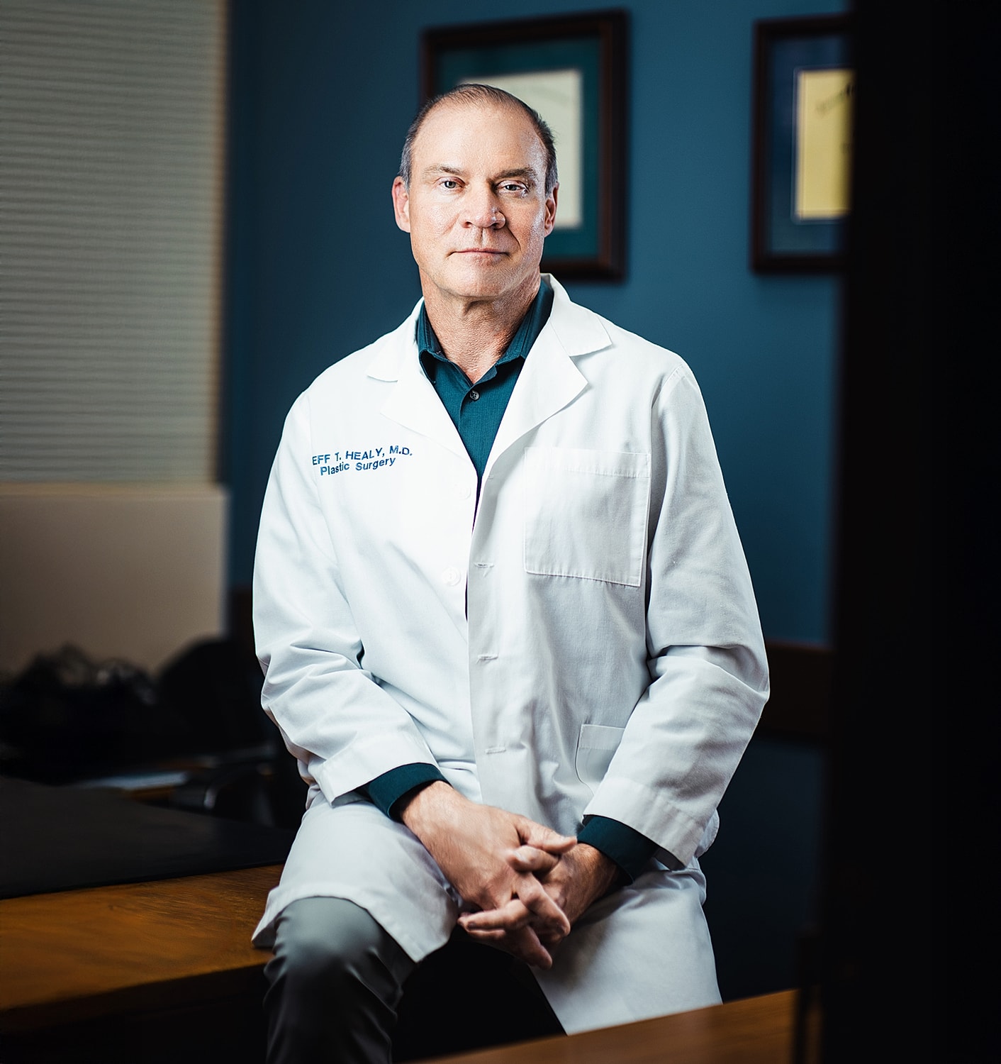 Male doctor in white coat, plastic surgery office.