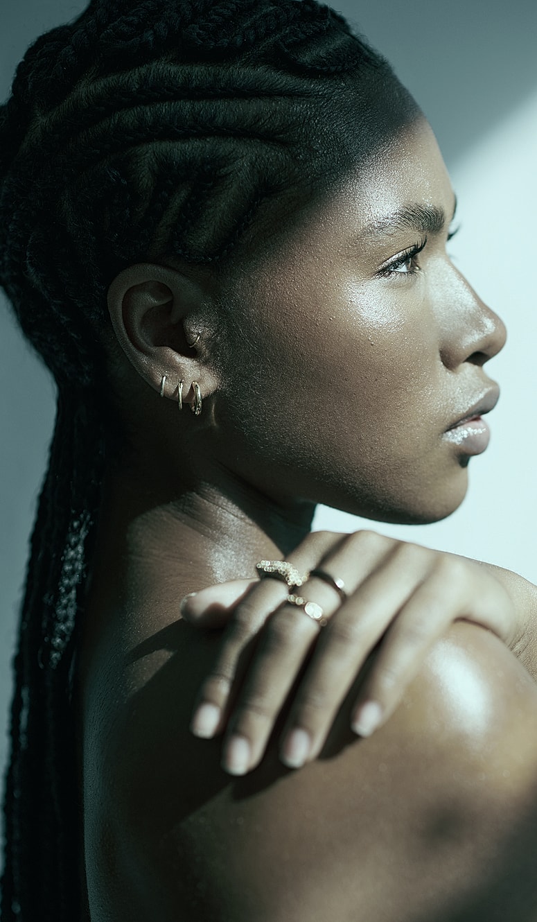 Woman with braided hair and elegant jewelry.