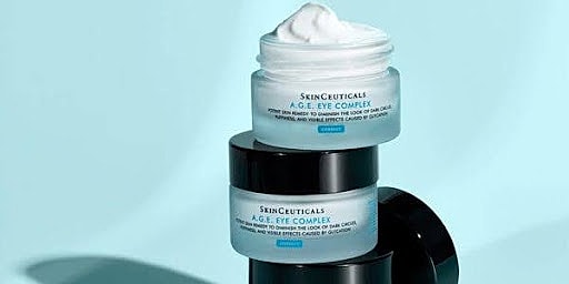 SkinCeuticals eye cream jars on blue background.