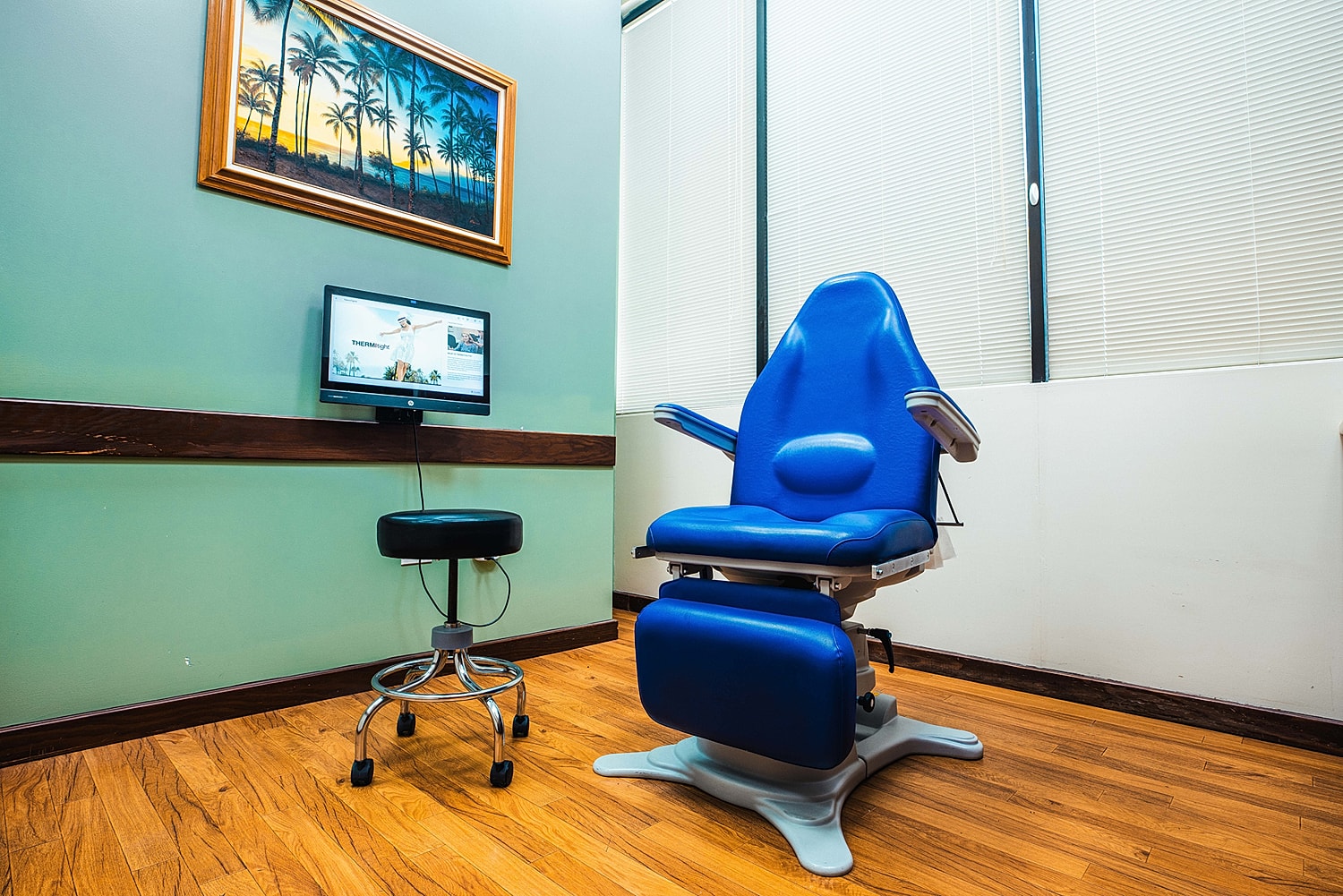 Medical examination room with a blue chair.
