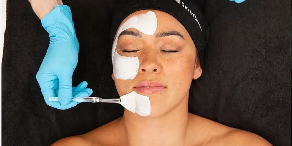 Woman receiving facial treatment in skincare session