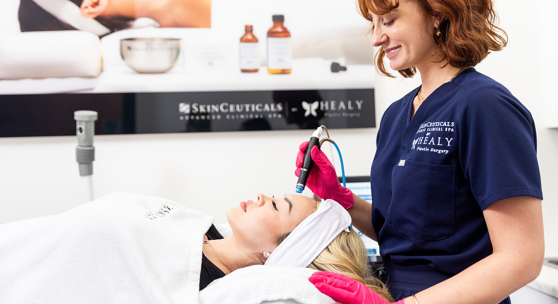Woman receiving facial treatment at clinical spa.